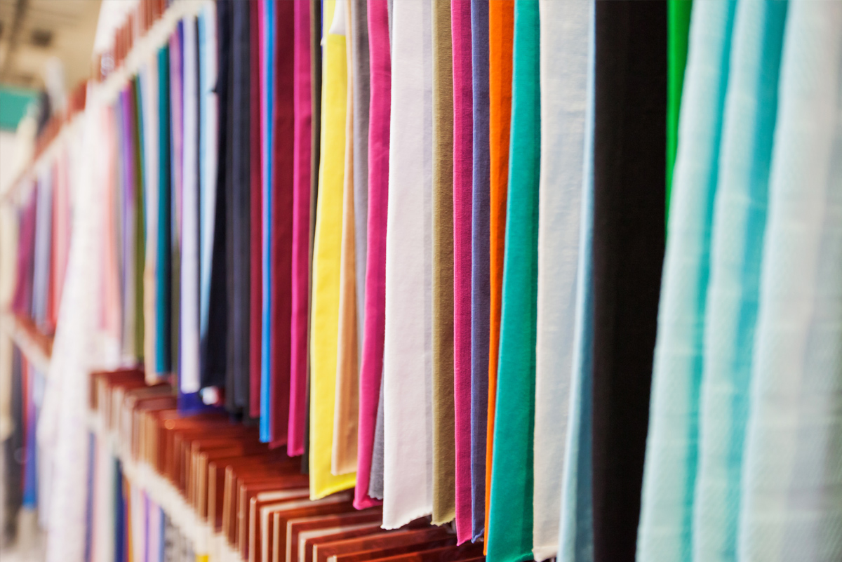 Vibrant fabric swatches on hangers for custom upholstery in Colorado interior design studio