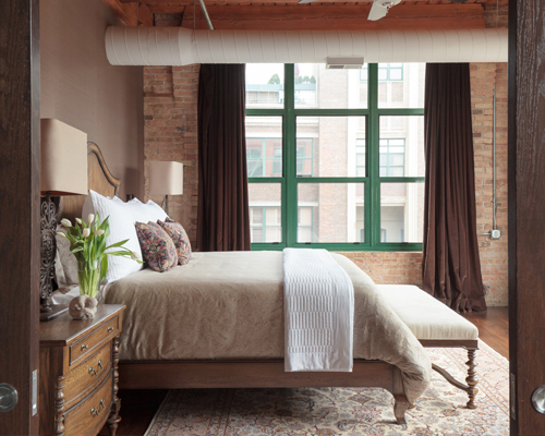Bedroom with exposed brick wall, rustic-chic Denver loft design