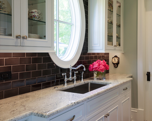Butler's pantry with black subway tile in Washington Park Denver home