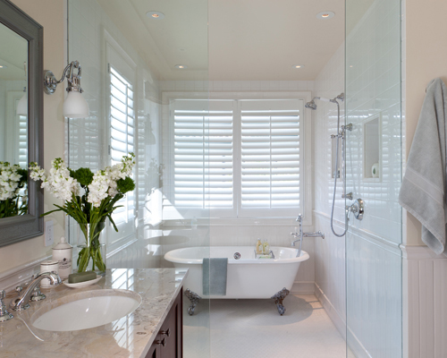 Shower and tub combination with white tile in Denver bathroom remodel