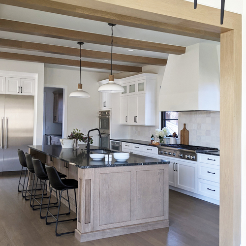 Transitional white kitchen with black counters and drywall hood in Denver